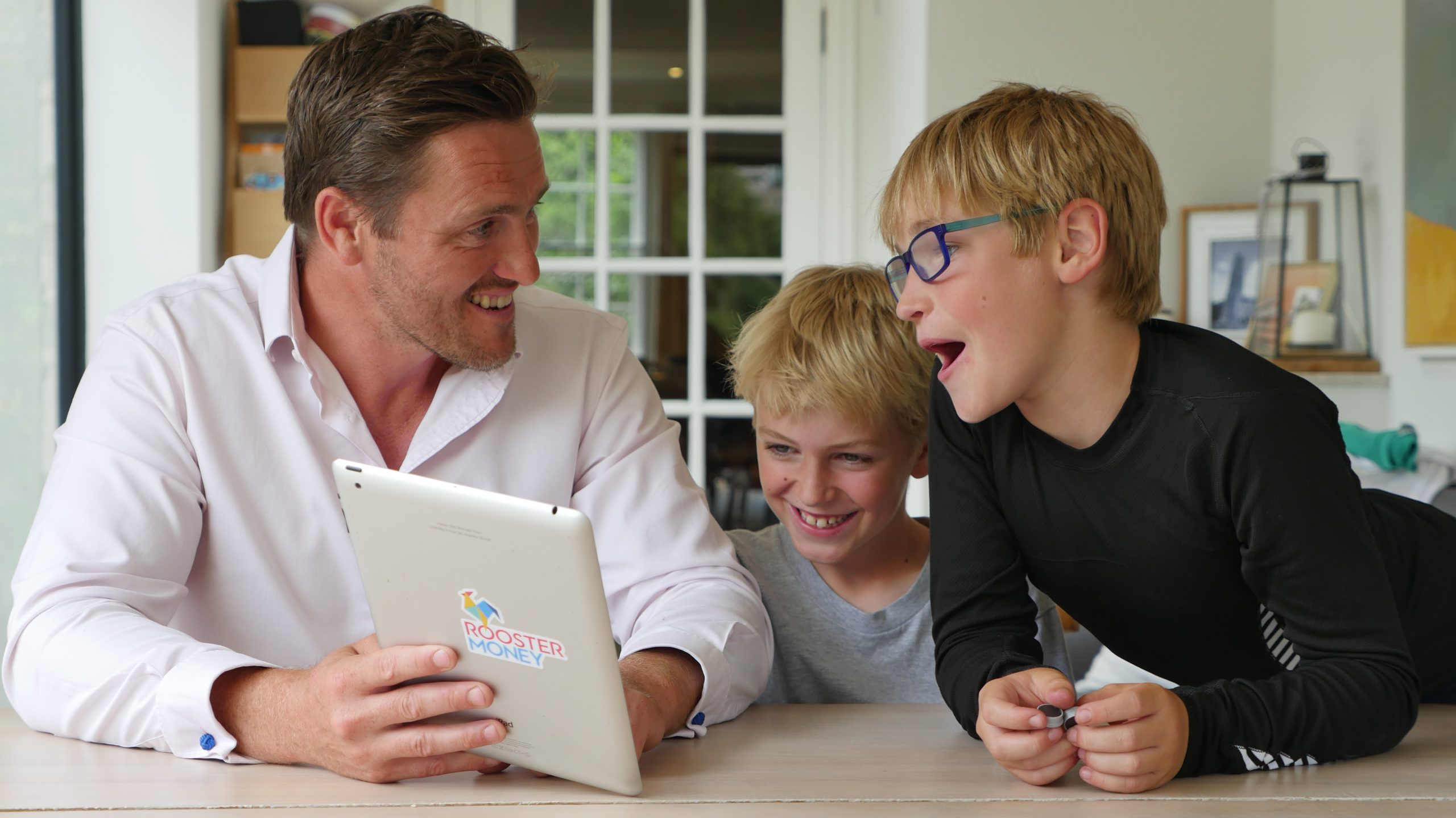 Dad showing RoosterApp on a tablet